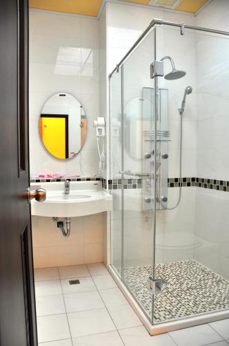 a bathroom with a shower and a sink at Fish Fun House in Hualien City