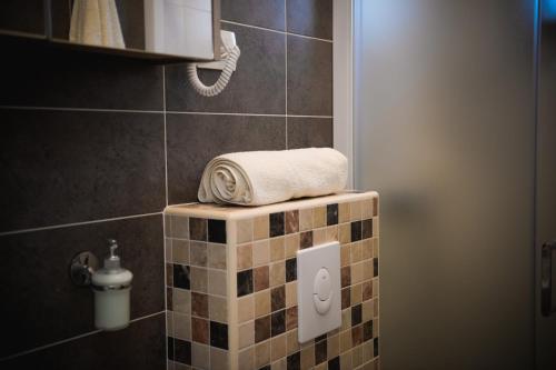 a bathroom with a towel on a tiled wall at Apartment Markioli in Povlja