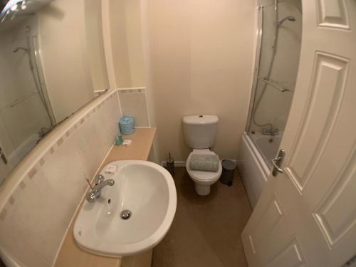 Baño pequeño con lavabo y aseo en Harpers brook house, Netflix TVs and fast WIFI, en Corby