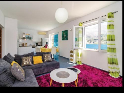 a living room with a couch and a table at Beach Heaven Home in Slano