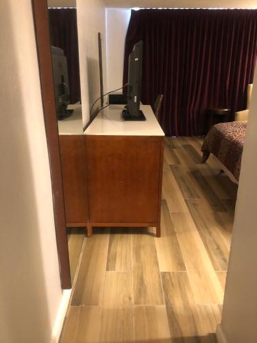 a room with a desk with a computer on it at Western Inn in Houston