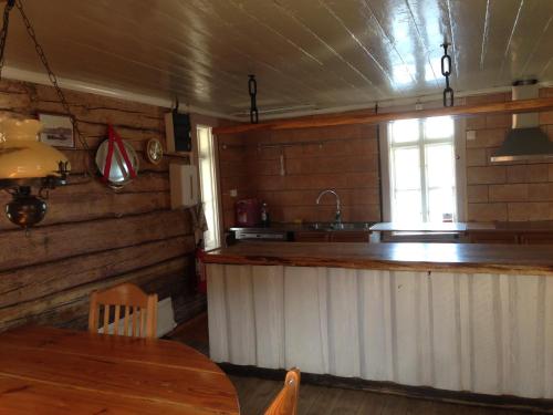 a kitchen with a counter and a sink and a window at Vandrarhemmet Lotsen in Dalarö