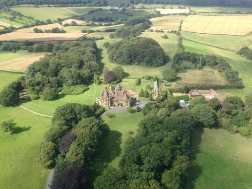 an aerial view of a house in a field at The Wrea Head Hall Country House Hotel & Restaurant in Scarborough