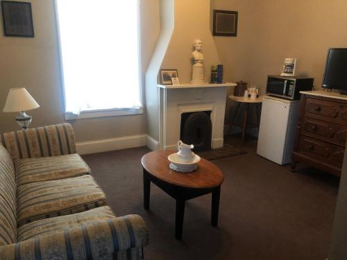 a living room with a couch and a coffee table at Talbott Tavern and Inn in Bardstown