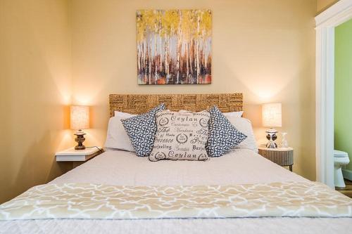 a bed with blue and white pillows in a bedroom at The Campbell House Inn in Eugene