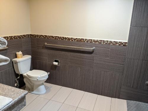 uma casa de banho com um WC e um lavatório em Passport Inn & Suites em Corona