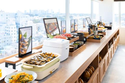 a buffet line with many different types of food at Vessel Inn Keisei Tsudanuma Station in Narashino