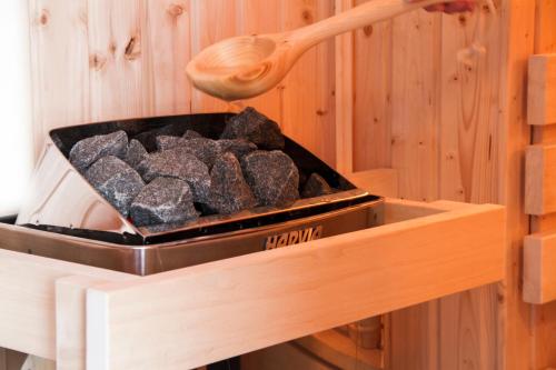 a wooden spoon sitting on top of a box filled with rocks at Captain’s Rest in Dunvegan