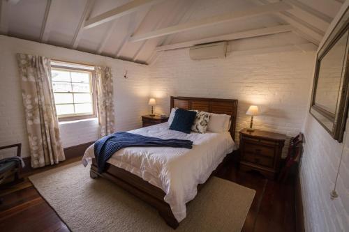 a bedroom with a large bed and a window at The Barracks, Tocal in Paterson