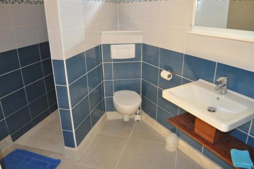 a bathroom with a toilet and a sink at Infiniti Blue in Bouillante