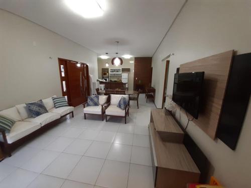 a living room with couches and a flat screen tv at Casa de Praia Luis Correia in Luis Correia