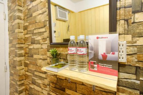 two bottles of water sitting on a counter at RedDoorz near OWWA Pasay in Manila