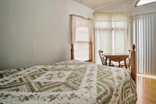 a bedroom with a bed and a table and a window at Lakefront Geneva Vacation Rental - Walk to Strip! in Geneva-on-the-Lake