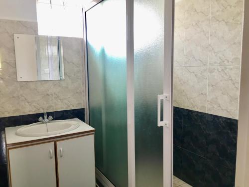 a bathroom with a sink and a shower at Le Palmier - 4 bedrooms BeachFront villa - Gated Complex in Flic-en-Flac