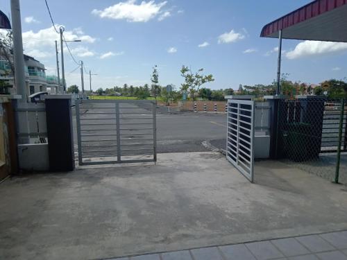 an empty parking lot with a gate at a gas station at Hazz Homestay Alor Setar in Alor Setar