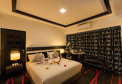 a hotel room with a large bed and a telephone at The Pearl in Hassan