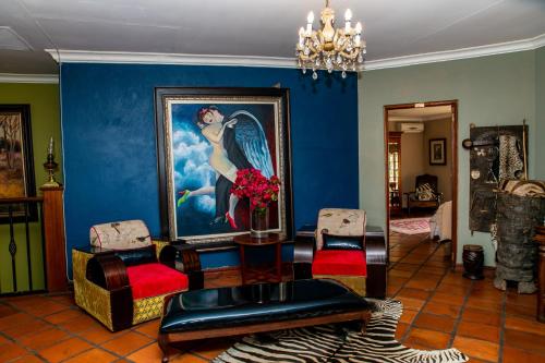 a living room with a painting on the wall at Terra Casa Guesthouse in Rustenburg