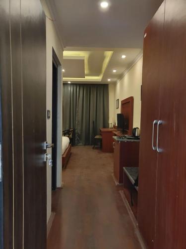a hallway of a hotel room with a bed and a desk at Hotel Paradise Ladakh in Leh