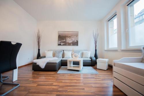 a living room with a couch and a table at Ferienparadies in Fürth