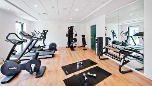 a gym with treadmills ellipticals and exercise bikes at Kyriad Résidence Cabriès - Plan de Campagne in Cabriès