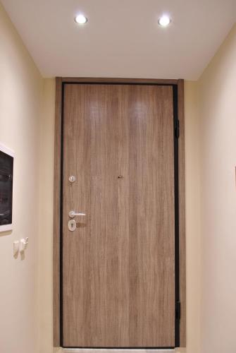 a wooden door in the corner of a room at Studio 20 (the best spot in town !) in Patra