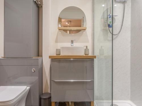 a bathroom with a sink and a shower at Potters by the Sea in Penzance