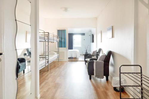 a living room with a staircase and a living room with a couch at Hotell Vesterhavet in Falkenberg