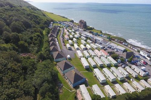 an aerial view of a group of buildings next to the water at The 'Croyde' Caravan in Bideford