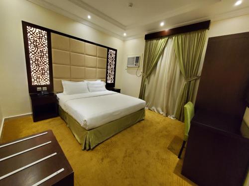 a hotel room with a bed and a window at Quiet Dreams - Quraysh Branch in Jeddah