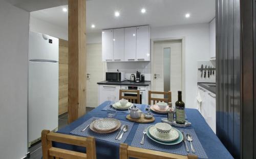 a kitchen with a table with a blue table cloth at Hotel Hvezda in Pec pod Sněžkou
