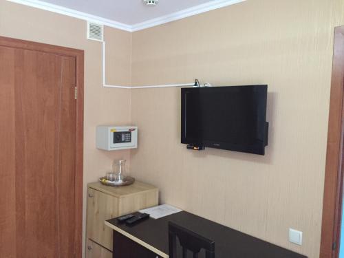 a room with a flat screen tv on the wall at Patio MiniHotel in Tolyatti