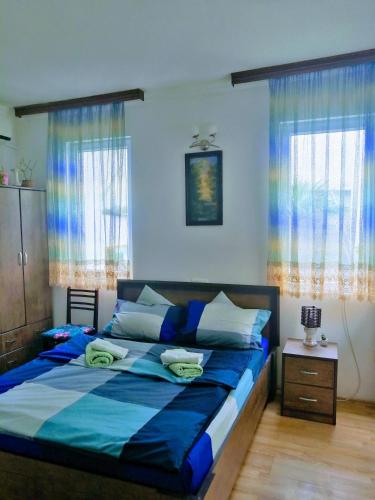 a bedroom with a large bed with blue sheets at Guest House Marina in Tbilisi City