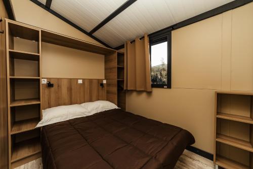a bedroom with a bed and a window at Oasi Camping in Diano Marina