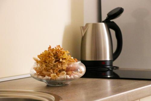 een kom popcorn op een aanrecht naast een koffiepot bij Apartman Ana in Skradin