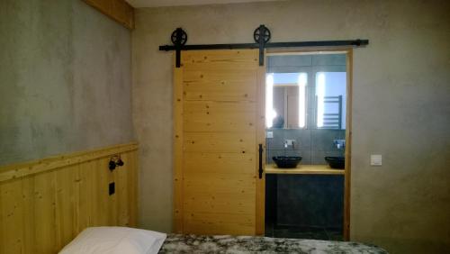 a bedroom with a door to a bathroom with a sink at Matangie in Praranger