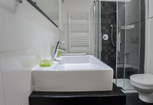 a white bathroom with a sink and a toilet at Il Mondo di Patty 2 in Pera