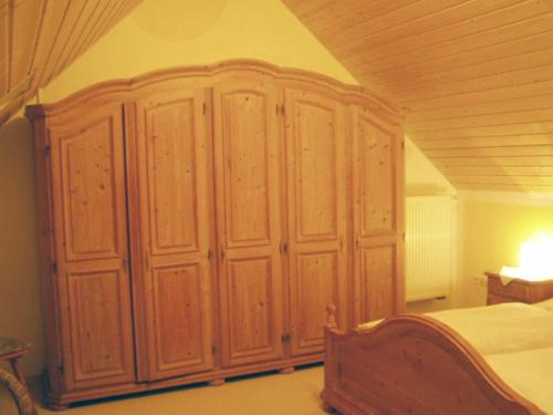 a large wooden cabinet in a bedroom at Ferienwohnung Hartinger in Wolfersdorf