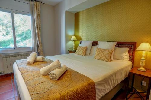 a bedroom with a large bed with towels on it at Montroig Zen Penthouse by Hello Homes Sitges in Sitges