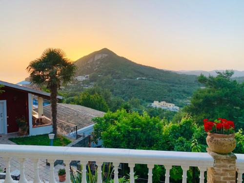 a balcony with a view of a mountain at Ermones Emerald Villa in Vátos