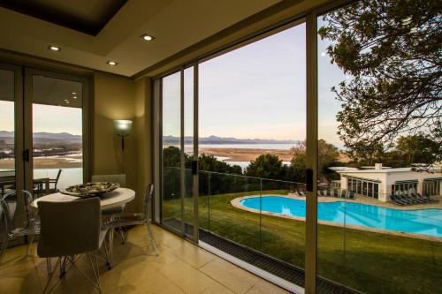 a house with a view of a pool and a dining room at No1 Sangaree in Plettenberg Bay