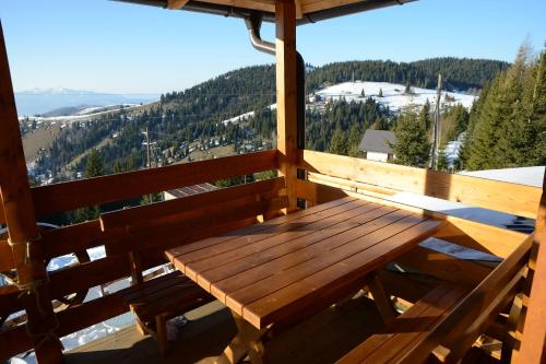 a wooden bench sitting on the balcony of a cabin at Resort Skrivena in Berane