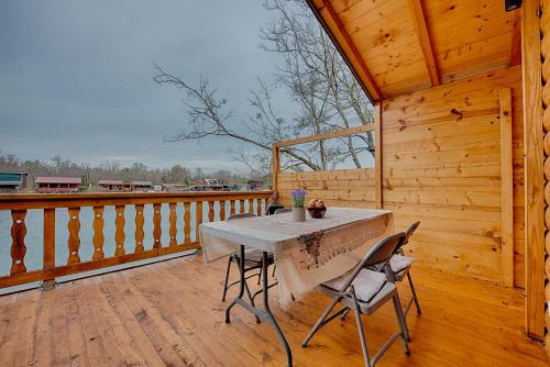 a wooden porch with a table and chairs on a deck at Rejan Lux in Ulcinj