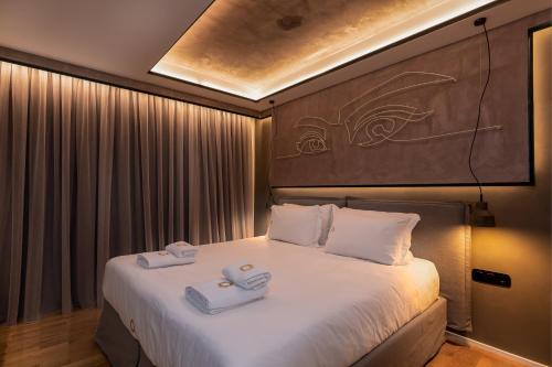 a bedroom with a bed with two towels on it at Onira Suite Dreams in Hersonissos