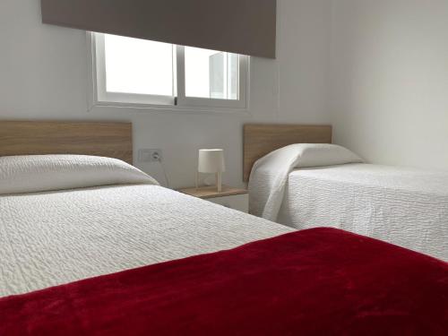 Cama o camas de una habitación en Apartamentos Tao Iker
