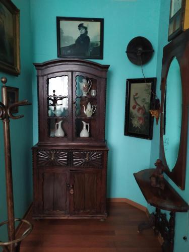 a wooden cabinet in a room with blue walls at Vilni Kimnaty in Mukacheve