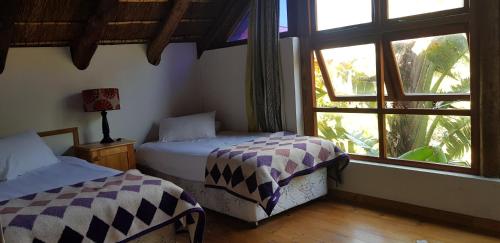 Ένα ή περισσότερα κρεβάτια σε δωμάτιο στο Pirates Creek Self-Catering Chalets