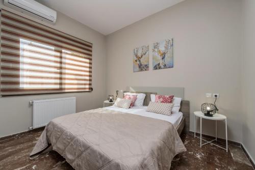 a bedroom with a large bed and a window at Bright & Stunning Flat in the City Centre in Zakynthos Town