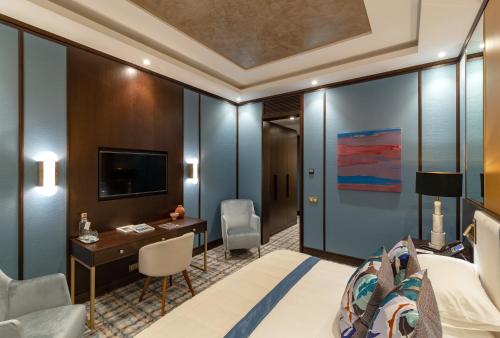 a hotel room with a bed and a desk at SOHO boutique hotel in Dnipro