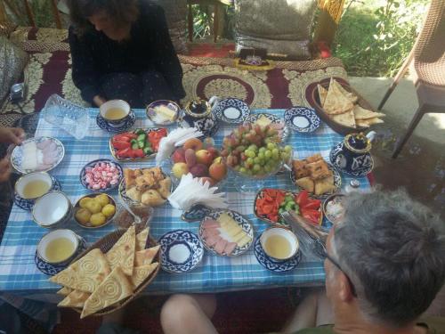a table with a bunch of food on it at Guest House Khiva BOYJON OTA in Khiva