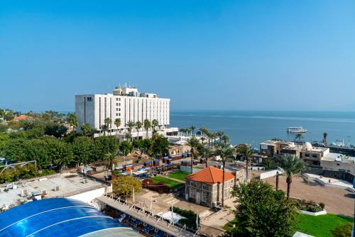 an aerial view of a city with a large building at Leonardo Club Tiberias - All Inclusive in Tiberias